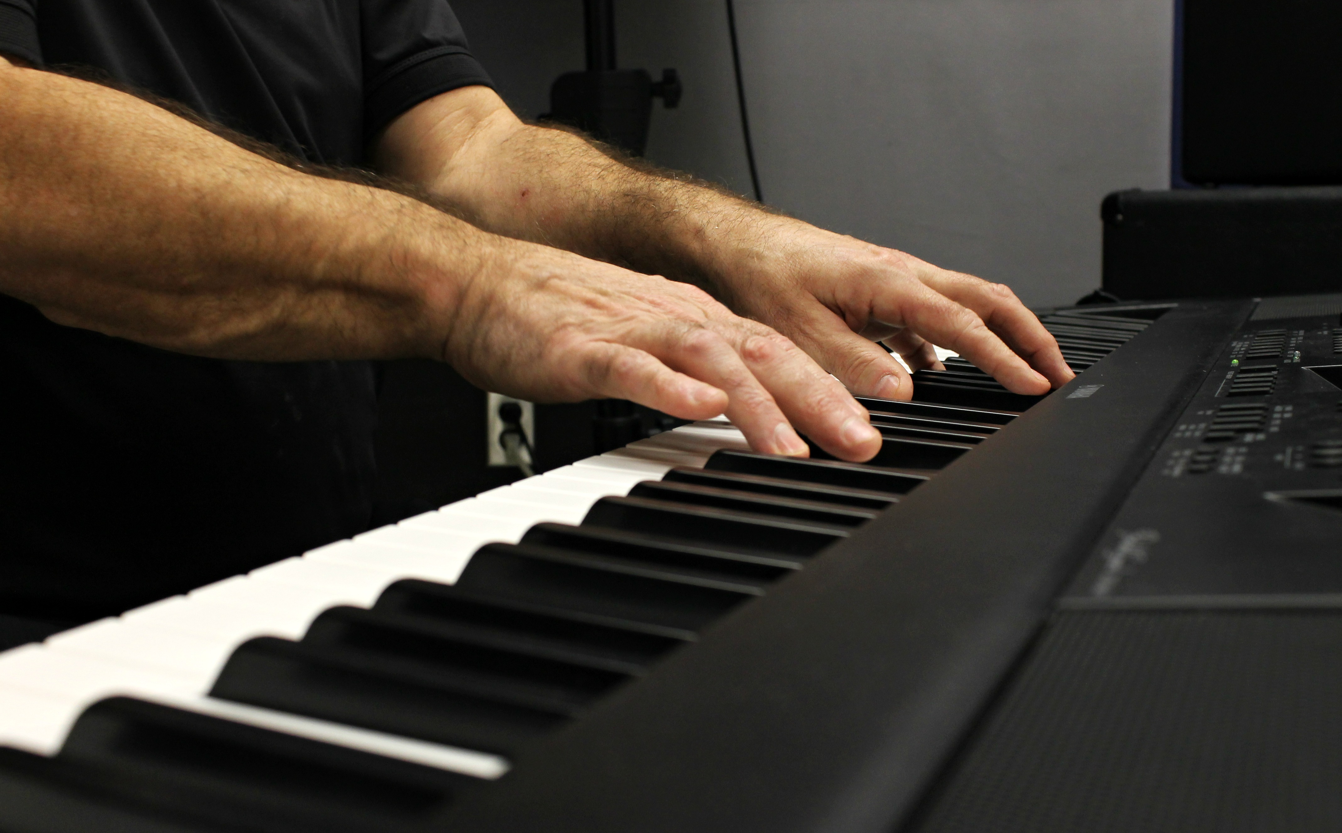 hands on piano keyboard